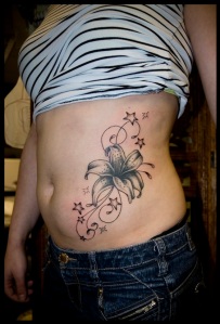 Lily and stars waist/side tattoo